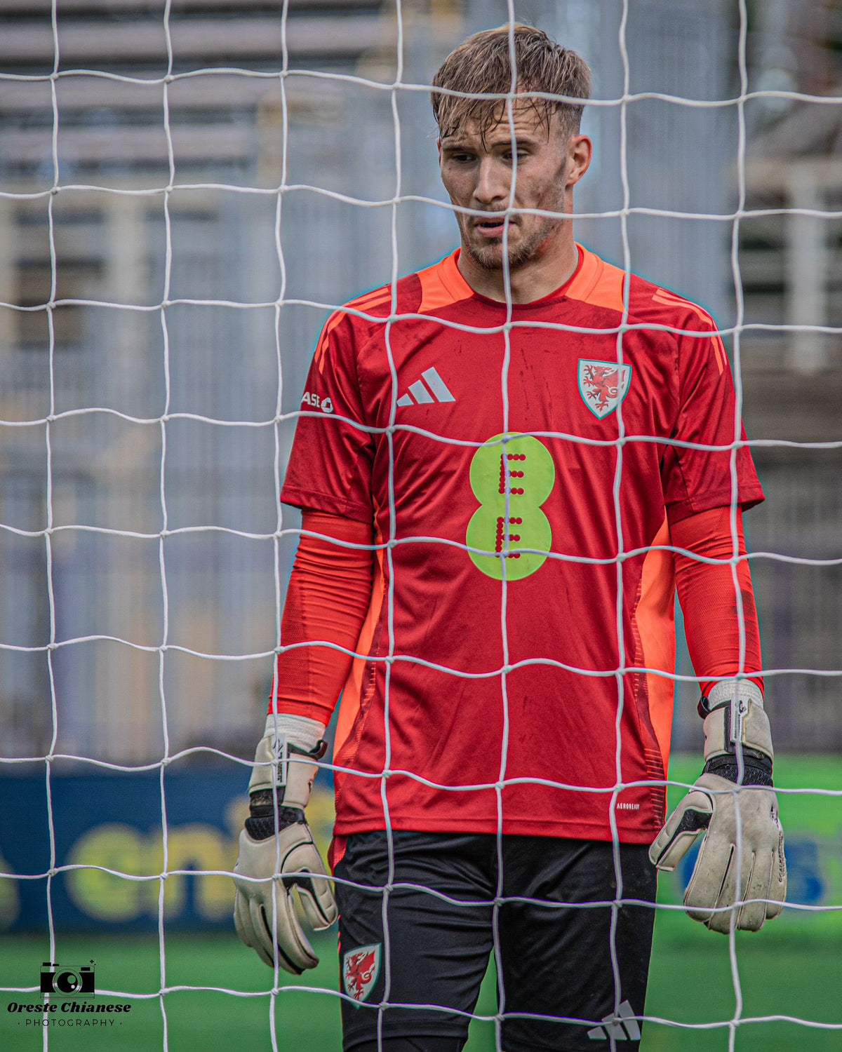 Ewan Griffiths of Wales U19 standing in goal behind the net in DZL Classix goalkeeper gloves